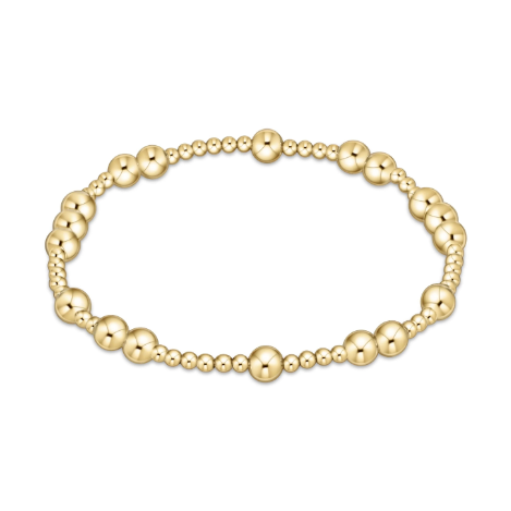 Polished yellow gold stretch bracelet featuring an alternating pattern of large and small spherical beads on a clean white background