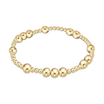 Polished gold beaded stretch bracelet featuring alternating large and small round beads