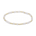Stretch bracelet featuring alternating white pearls and small gold beads
