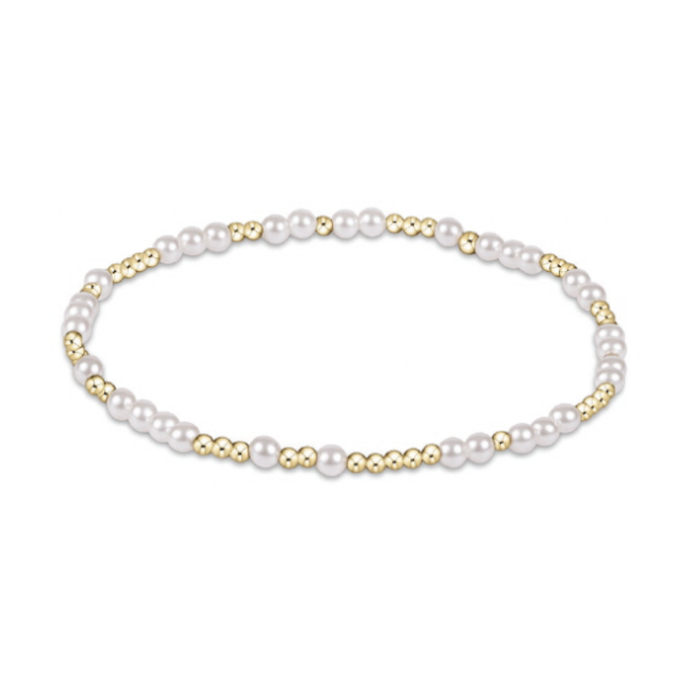 Stretch bracelet featuring alternating white pearls and small gold beads
