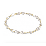 Stretch bracelet featuring alternating gold beads and white pearls