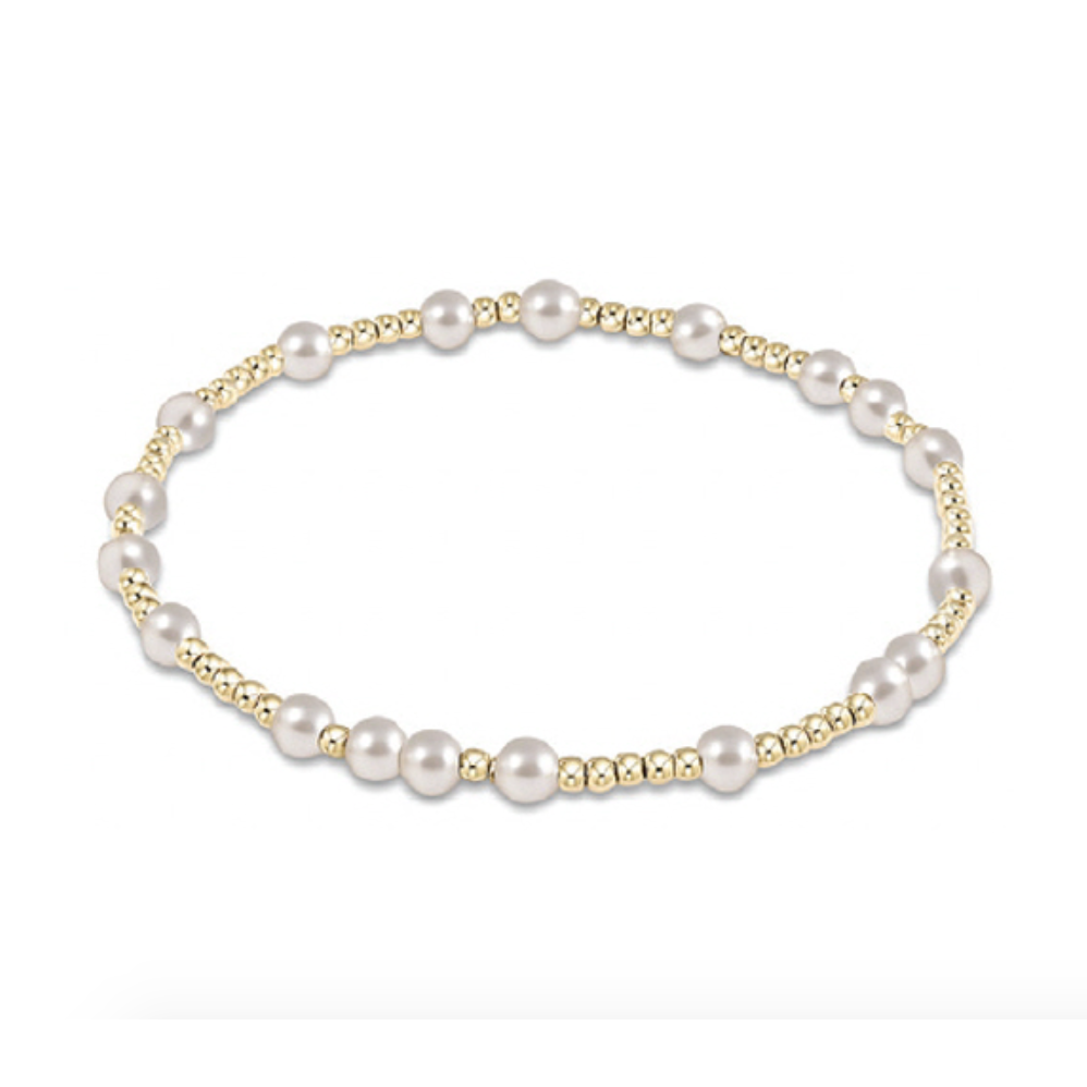Stretch bracelet featuring alternating gold beads and white pearls