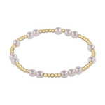 Stretch bracelet with alternating gold beads and white pearls