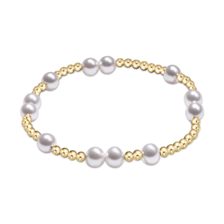 Stretch bracelet featuring alternating gold beads and white pearls