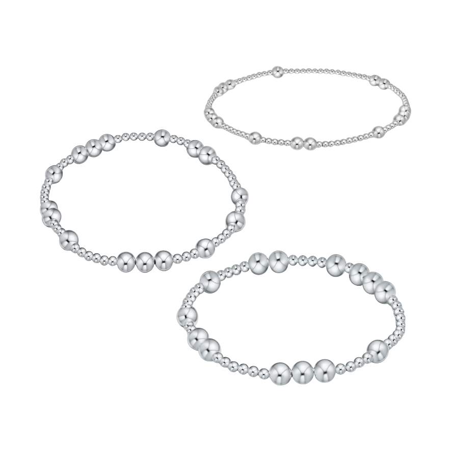 Three silver beaded stretch bracelets with varying bead sizes
