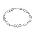 Silver stretch bracelet with alternating sizes of polished metal beads