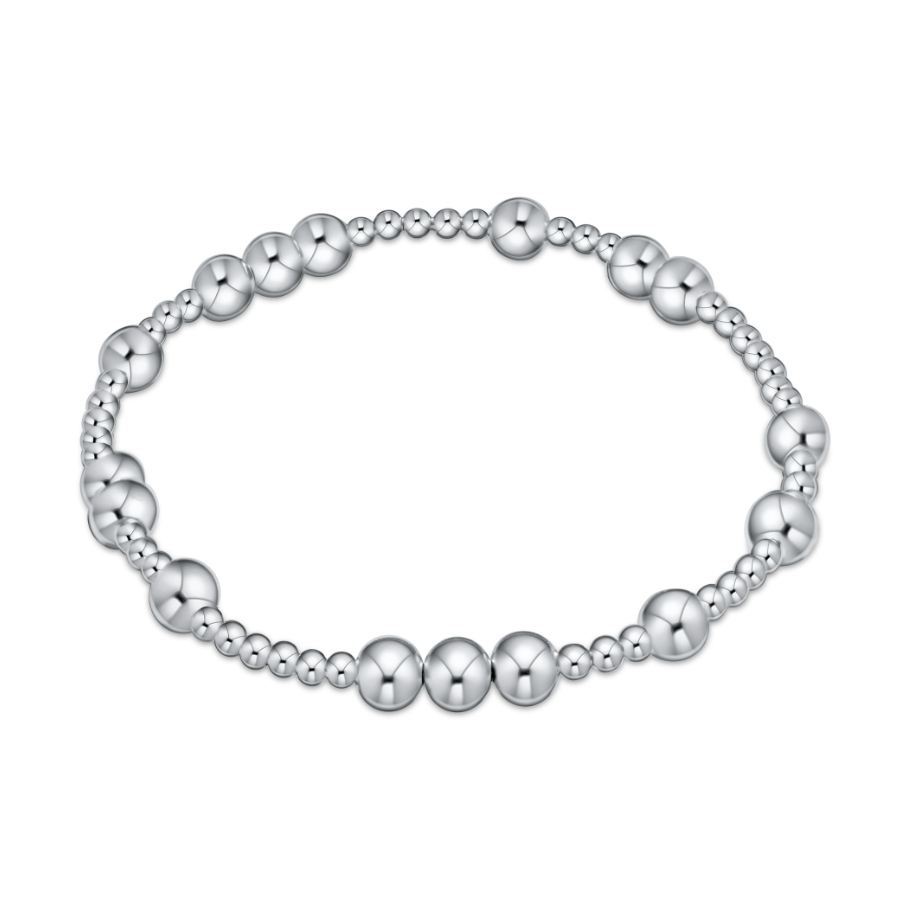 Silver stretch bracelet with alternating sizes of polished metal beads