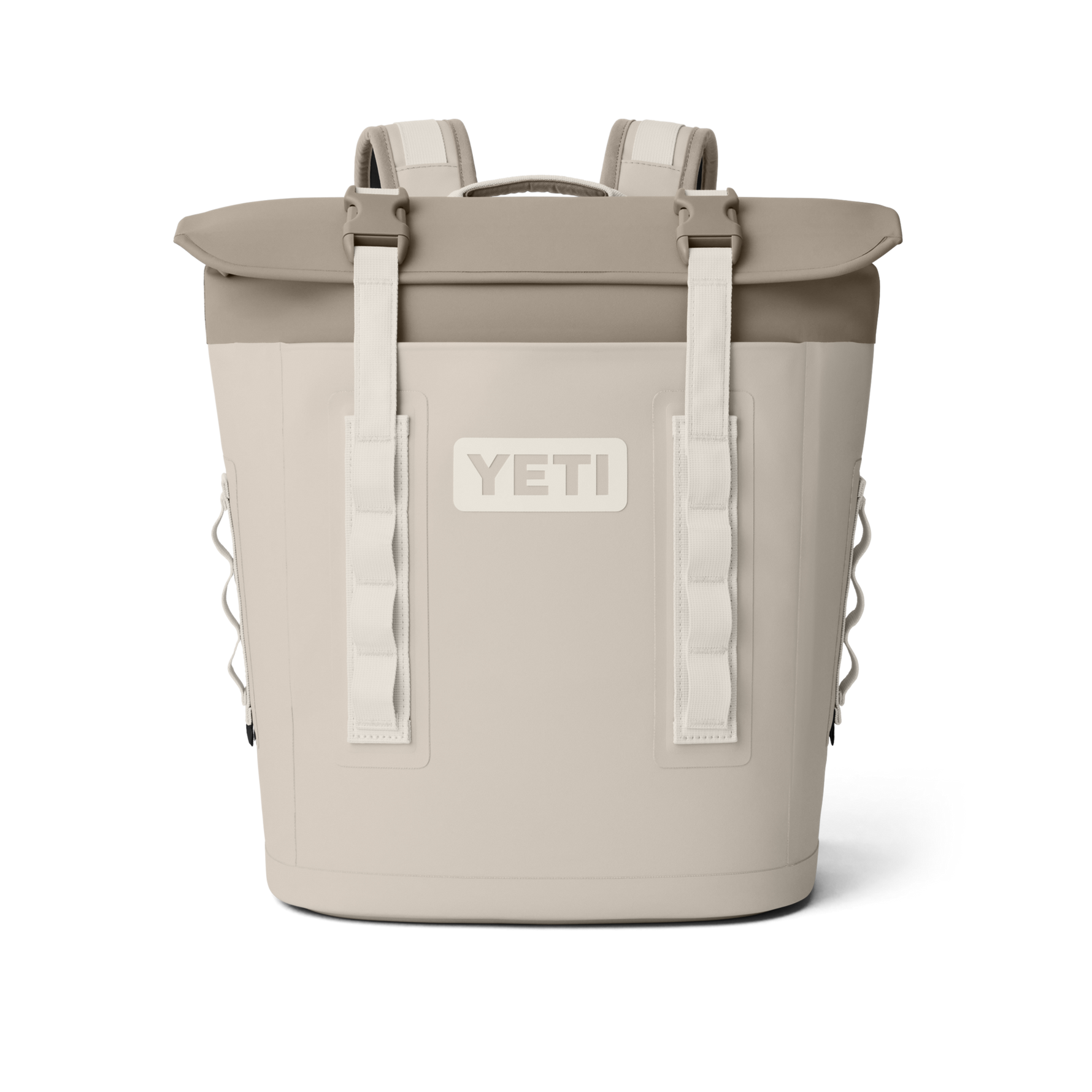 Product image of a two-tone beige and tan Yeti Hopper M20 Soft Cooler Backpack featuring a prominent Yeti logo, white buckle straps securing the roll-top closure, and padded shoulder straps