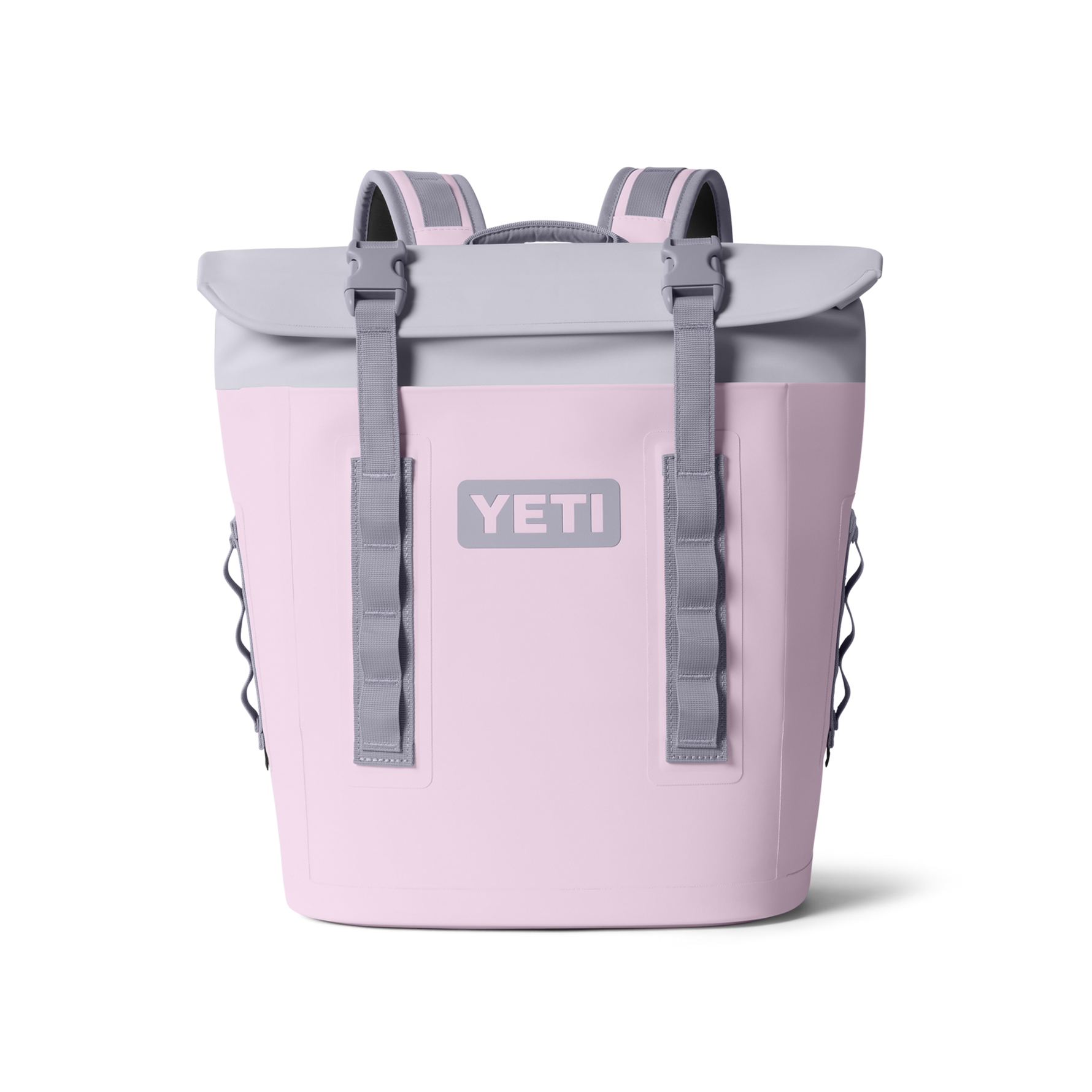 Blush pink YETI cooler backpack featuring a light grey roll-top closure, grey buckle straps, padded shoulder straps, and a prominent YETI logo