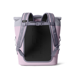 Yeti pink and light gray cooler backpack with a roll-top closure and embossed Yeti logo on the dark gray back panel