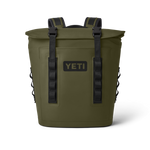 Product photography of an olive green YETI soft cooler backpack on a black background showcasing its roll-top closure, black YETI logo, and two black buckle straps with side molle webbing