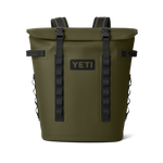 YETI olive green soft cooler backpack featuring a roll-top closure, bold black YETI logo, and durable black buckle straps