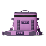 A lavender YETI Hopper Flip soft cooler bag featuring two YETI logos, a prominent black zipper, and a detachable grey shoulder strap on a plain studio background