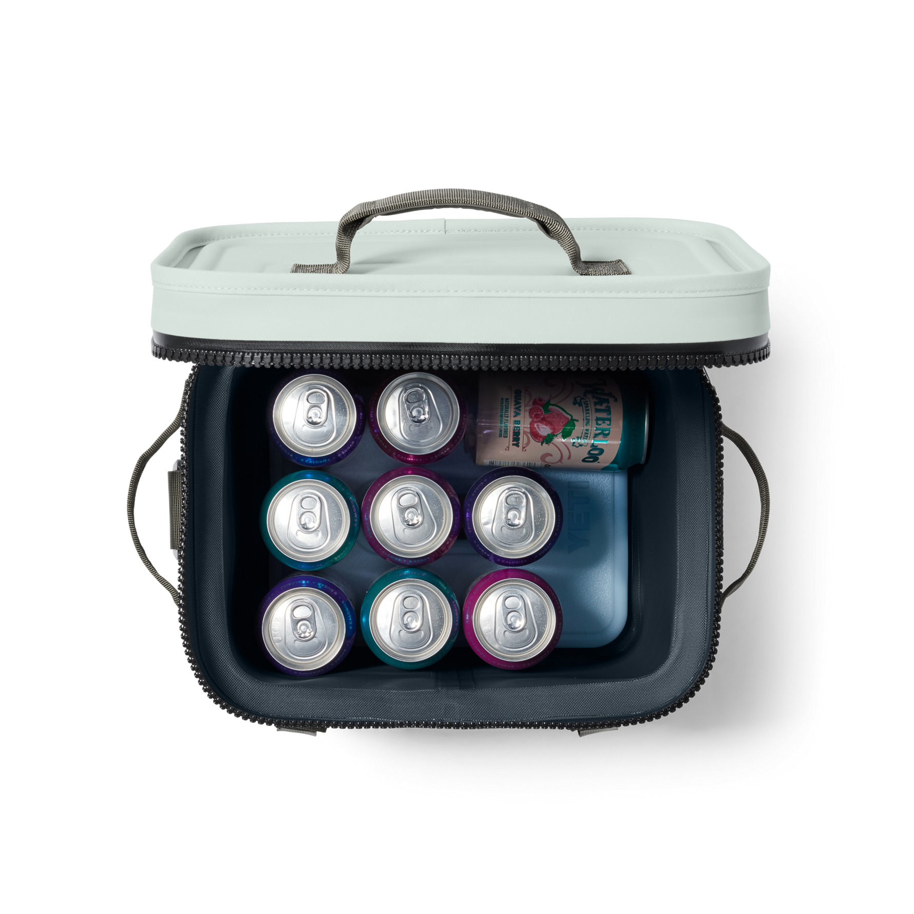 An overhead studio shot of an open light mint-green and dark grey portable cooler filled with nine colorful purple and teal cans, one green Waterloo Guava Berry sparkling water can, and a blue Yeti ice pack
