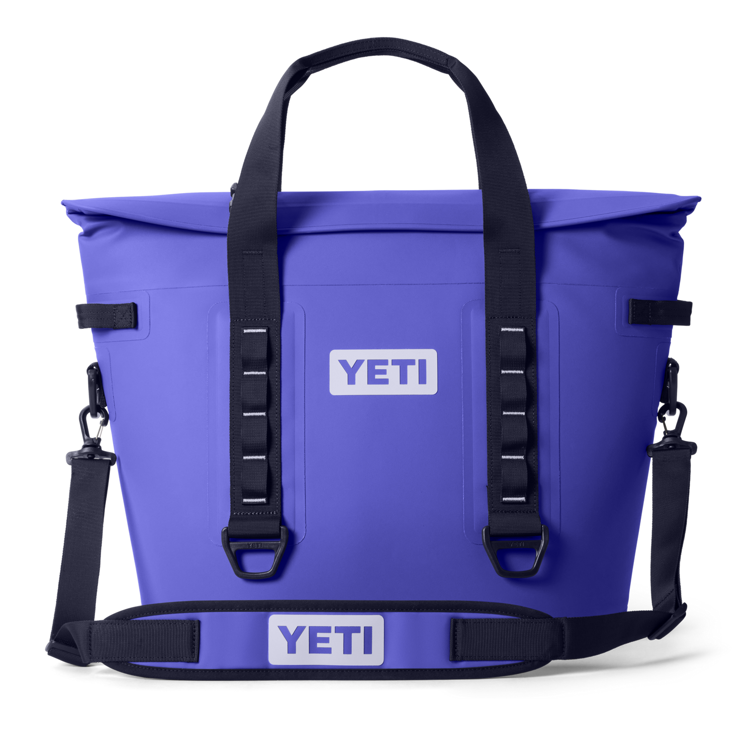 Vibrant purple Yeti soft cooler tote bag with a waterproof roll-top closure, black adjustable shoulder strap, and a prominent white YETI logo on the front and strap pad