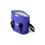 Periwinkle blue YETI Hopper M20 soft cooler bag open to show its light grey interior with the white YETI logo on the side and a black shoulder strap featuring HOPPER M20 text against a black background