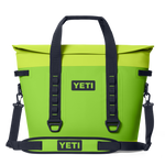 Digital product photo, YETI Hopper M30 soft cooler bag in bright chartreuse green on a black background showcasing its black YETI logo, roll-top closure, and durable black webbing handles with a detachable shoulder strap