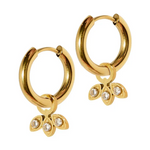 A pair of radiant gold hoop earrings each featuring a dangling three-petal charm adorned with three brilliant clear stones