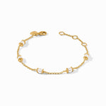 Gold chain bracelet featuring spaced white pearls with textured gold bead accents