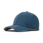 Photography of a dusty blue performance baseball cap featuring perforated side panels, an embossed logo on the front, and a curved brim