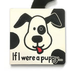 Board book cover featuring a black and white cartoon puppy face with a black eye patch, a red tongue sticking out, a visible black fuzzy tail, and the title text "If I were a puppy..."