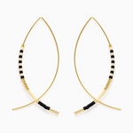 A pair of gold-tone wire open hoop earrings featuring a segment of alternating black and cream striped beads accented with gold seed beads and gold tube ends