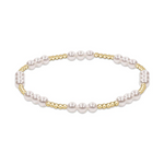 Product image of an elegant stretch bracelet designed with lustrous white spherical pearls arranged in groups interspersed with clusters of small gold beads