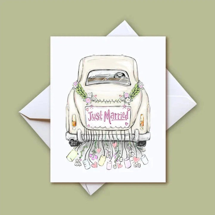 Illustration of a white vintage wedding car with a pink "Just Married" sign adorned with green leaves and small pink flowers, trailing colorful bottles and hearts from the bumper, presented as a greeting card on a light green background
