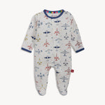 White baby sleepsuit with a colorful airplane and star print featuring red, blue, and yellow planes, navy blue trim, and a rainbow stripe on the inner collar