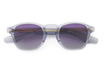 Product photograph of Dita sunglasses featuring transparent grey acetate frames, purple-to-grey gradient lenses, and gold-toned metal core wire details against a white background