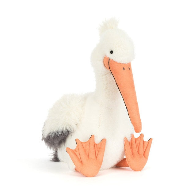 Plush pelican toy with white fur and orange beak and feet