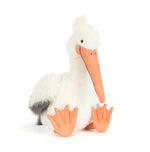 Plush toy Jellycat white pelican with a fluffy head crest sitting on a plain white background featuring a long bright orange beak matching orange webbed feet and a soft grey patch on its back