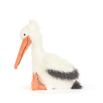 Plush toy pelican with a fluffy white body and dark gray back accents, featuring a long orange fabric beak with black stitching, small black bead eyes, and orange webbed feet on a plain white studio background