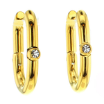 A pair of elegant polished gold-toned oval hoop earrings, each featuring a single bezel-set clear crystal on a white studio background