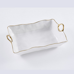 White ceramic rectangular serving tray with wavy gold-rimmed edges and two integrated gold ring handles on a plain white background