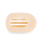 Pale peach oval razor cartridge with three visible blades and a faint circular logo against a solid black background