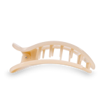 Light beige arched plastic hair claw clip with a smooth glossy finish and sturdy interlocking teeth isolated on a black background