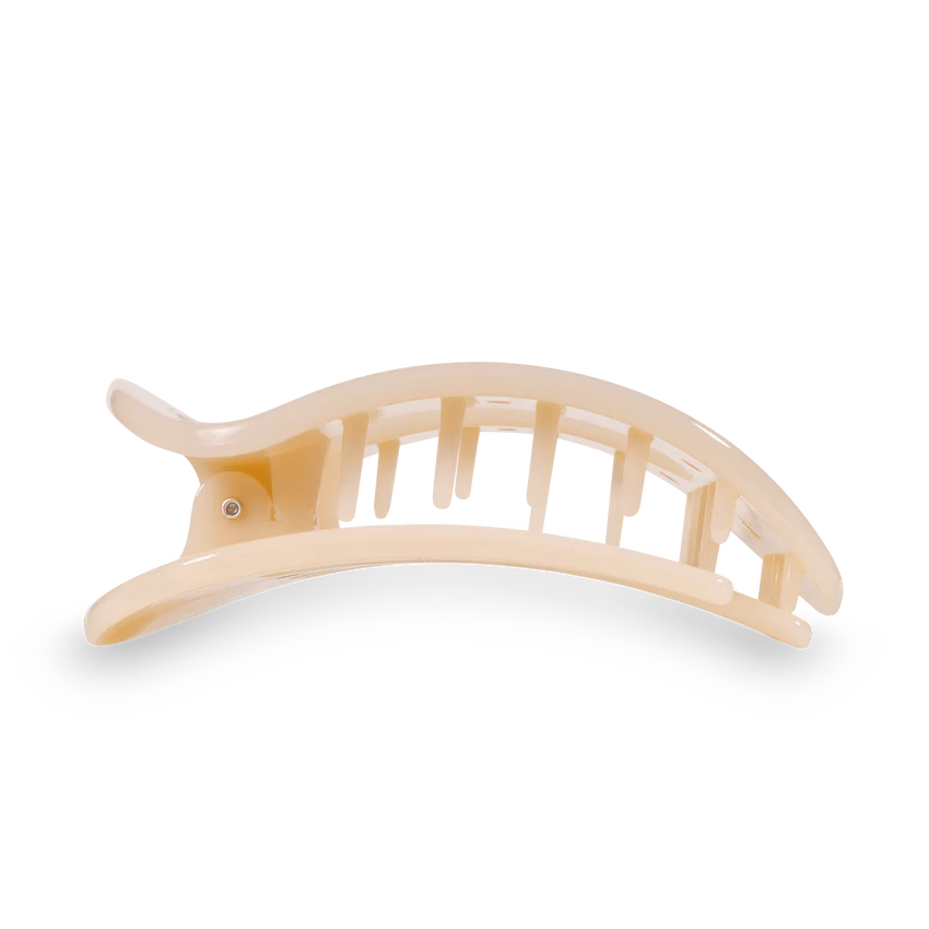 Light beige arched plastic hair claw clip with a smooth glossy finish and sturdy interlocking teeth isolated on a black background