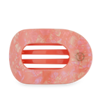 Resin iridescent peachy pink oblong hair claw clip with mottled pattern, coral pink internal teeth, and a gold T brand logo
