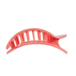 A large coral pink plastic hair claw clip featuring a curved, ribbed top jaw and visible hinged teeth