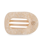 Mother-of-pearl patterned cream and beige oval soap dish with interior drainage ridges and a gold T logo bordered by small dots