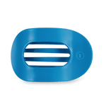 Studio shot of a matte blue oval object featuring four horizontal central slits and a small embossed circular logo with a letter T on the right, presented against a dark green background