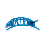 A bright blue plastic banana hair clip featuring a curved slotted top and a black rubberized bottom grip