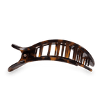 Tortoiseshell banana hair clip with brown and black mottled patterns, a curved design, and gapped teeth