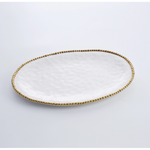 Oval white ceramic serving platter with a hammered texture surface and a gold beaded rim