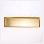 A rectangular gold-colored metal tray with a brushed finish presented on a white background