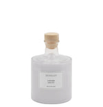 Archipelago lavender bubble bath in a clear glass bottle with a wooden stopper