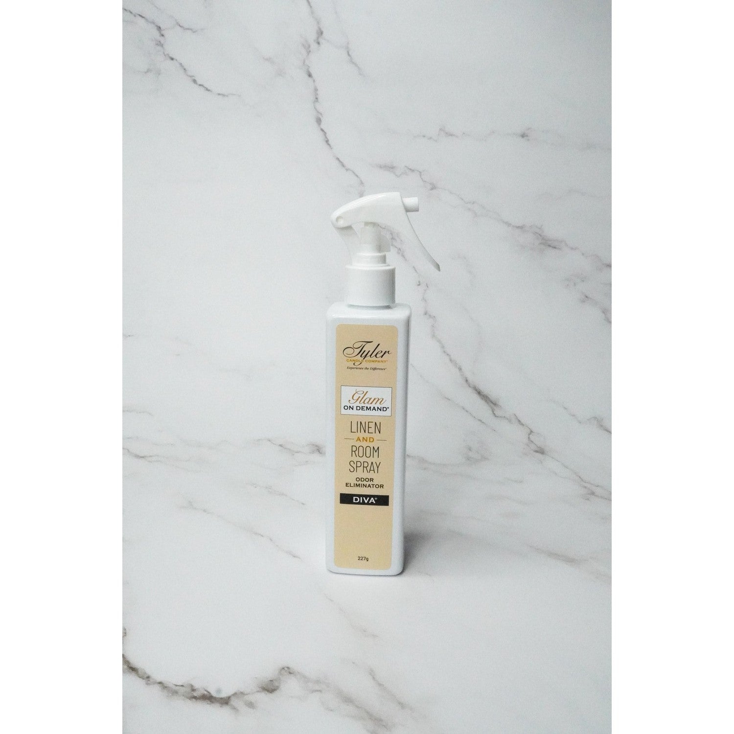 Tyler Candle Company Glam On Demand Diva linen and room spray bottle on a marble surface