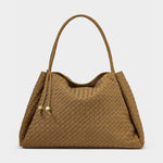 A camel woven leather shoulder bag with a braided top handle and decorative drawstrings featuring small gold hardware details