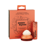 Product photography of Poppy & Pout Pomegranate Peach Lip Care Duo on a dark green background featuring a coral orange box with black poppy floral designs, a matching lip balm stick, and a small amber jar with white product, highlighting its eco-friendly flower-powered branding